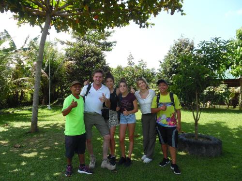 a group of people posing for a picture in a park at AMBOW Homestay Jungle Trekking & Village Tour in Bukit Lawang