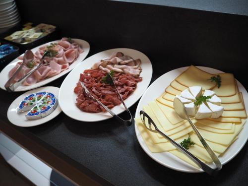 a table with four plates of food on it at Residence Hluboká in Hluboká nad Vltavou
