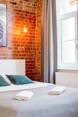 Postel nebo postele na pokoji v ubytování Sopot Loft