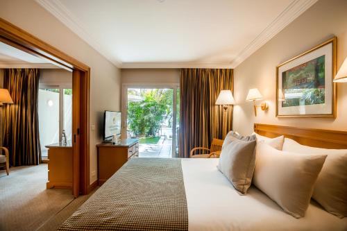 a hotel room with a bed and a sliding glass door at Aria in Eilat
