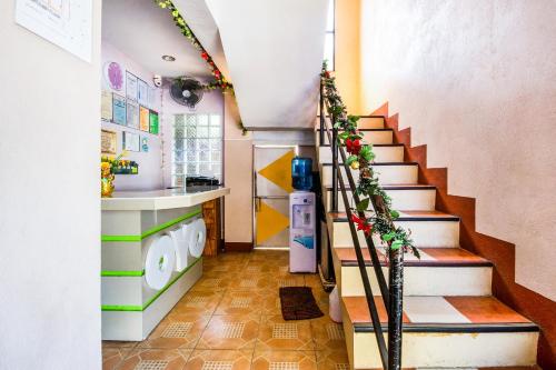 a staircase in a kitchen with a stairway with a washing machine at Casa Bonita Inn Oslob in Oslob