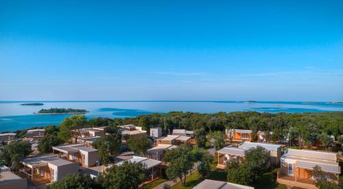 an aerial view of a city with houses and the ocean at Maistra Camping Veštar Mobile homes in Rovinj