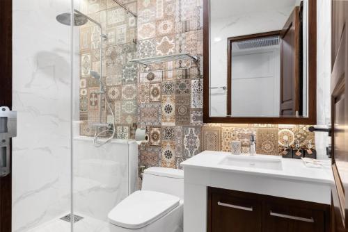 a bathroom with a toilet and a sink and a shower at ARUN Riverside Bangkok in Bangkok