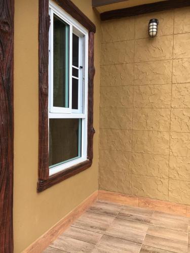 a room with a window and a tiled floor at นพรัตน์การ์เด้นฮิลล์ in Uthai Thani