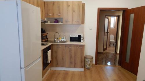 a small kitchen with a sink and a microwave at Serdika station, bright and cozy apartment in Sofia