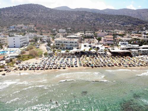 an aerial view of a beach with a bunch of umbrellas at Malliotakis Beach Hotel "by Checkin" in Stalida