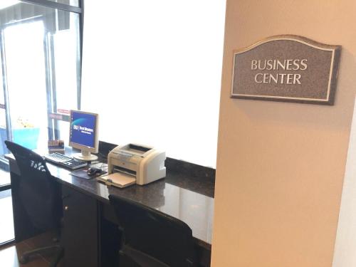a business center with a desk with a computer and a printer at Best Western Executive Hotel New Haven-West Haven in West Haven