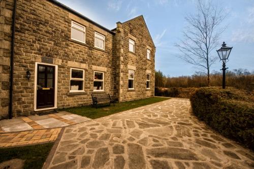 a brick building with a street light in front of it at Kedleston Cottage - Darwin Lake Holiday Village in Matlock