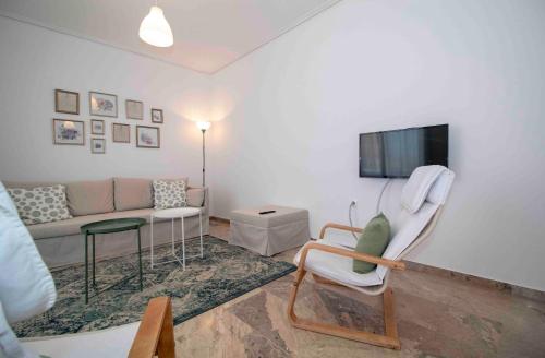 a living room with a couch and a tv at Laconian Collection #Othonos luxury apartment# in Sparti