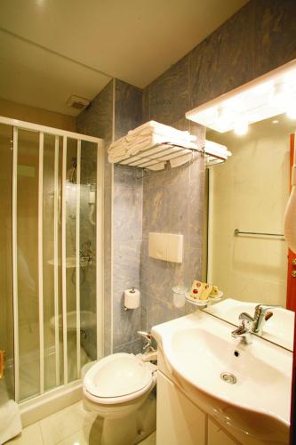 a bathroom with a toilet and a sink and a shower at Eurotel in Grottammare