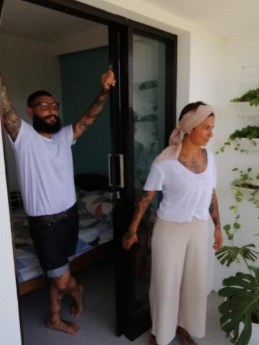 a man and a woman standing in a room at Happy House BnB Bromo backpacker in Probolinggo