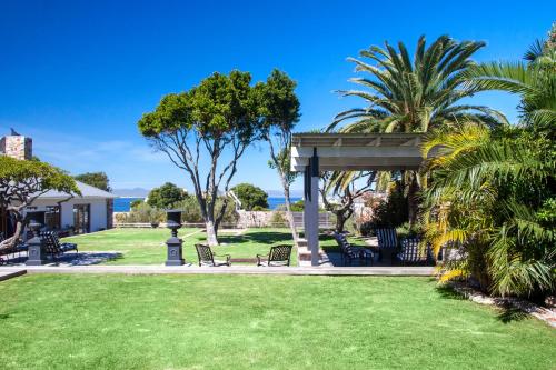 a gazebo in a park with palm trees at The Gregoire Boutique Villa in Hermanus