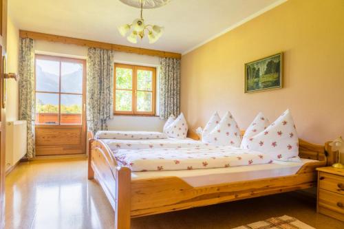 a bedroom with two beds and a window at Starbauer in Golling an der Salzach