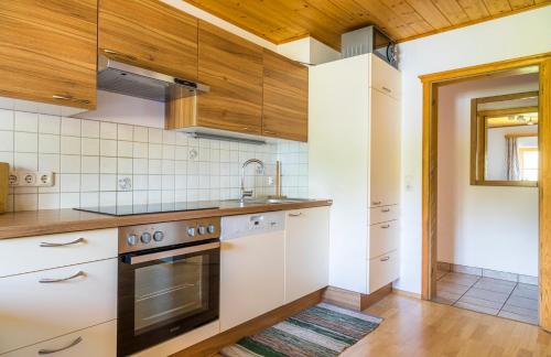 a kitchen with white appliances and wooden ceilings at Starbauer in Golling an der Salzach