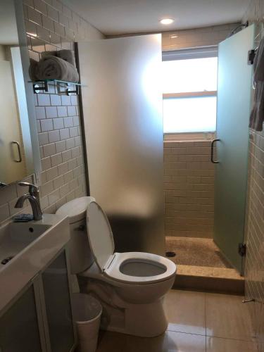 a bathroom with a toilet and a sink and a shower at Captiva Beach Resort (open private beach access) in Sarasota