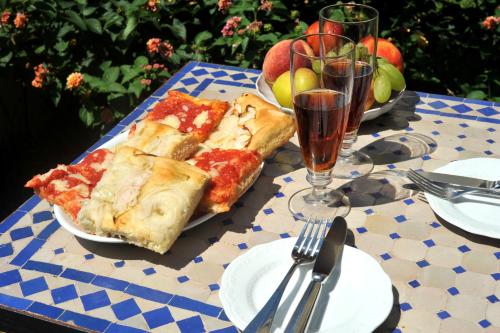a table topped with a slice of pizza and a glass of orange juice at Hotel La Casa sul Mare in Procida