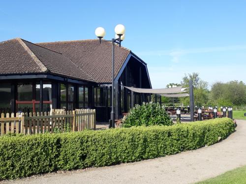 a black building with a fence in front of it at Weald of Kent Golf Course and Hotel in Maidstone
