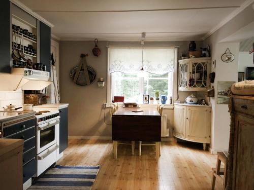 a kitchen with a table and a window in it at Lakeview in Casa Mia in Ljusdal