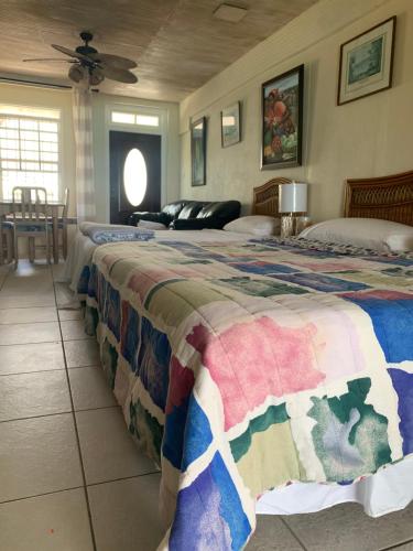 a bedroom with two beds and a ceiling at Beach Vue Barbados in Bridgetown