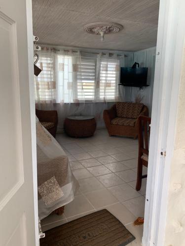 a living room with a couch and a television at Beach Vue Barbados in Bridgetown