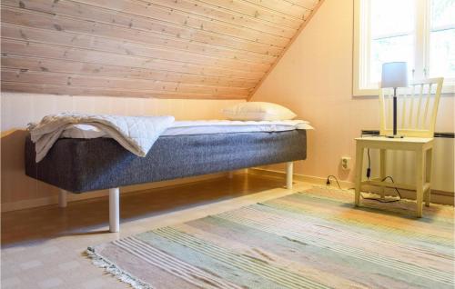 a bed in a room with a wooden ceiling at 2 Bedroom Amazing Home In Mörbylånga in Mörbylånga