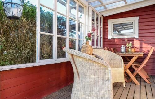 a patio with a table and chairs on a deck at 2 Bedroom Amazing Home In Mörbylånga in Mörbylånga