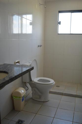 a bathroom with a toilet and a sink at Hotel Viru Viru II in Santa Cruz de la Sierra