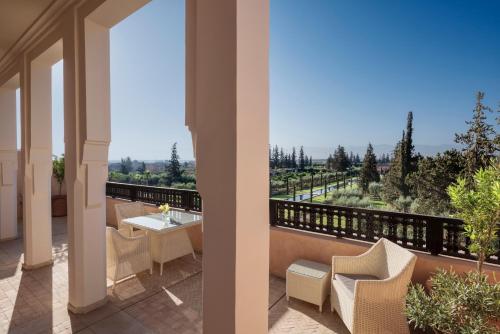 a balcony with a table and chairs and a view at The Oberoi Marrakech in Marrakech