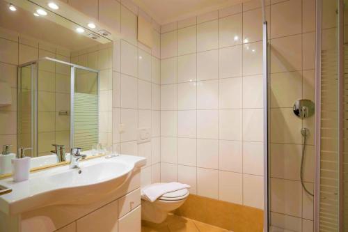 a bathroom with a toilet and a sink and a shower at Chalet Schott in Kirchberg in Tirol