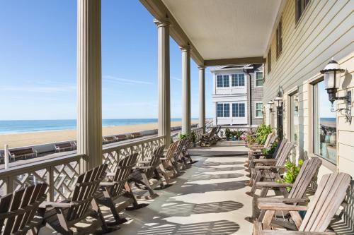 a row of chairs on a balcony overlooking the beach at Harrison Hall Hotel in Ocean City