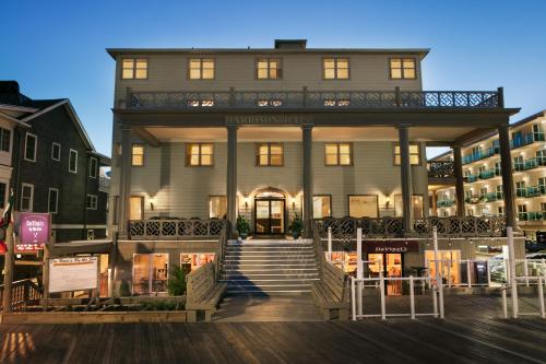 a large house with a staircase in front of it at Harrison Hall Hotel in Ocean City