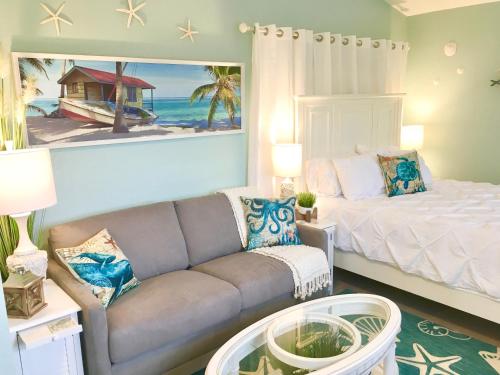 a living room with a couch and a bed at Coastal Studio Escape! in Naples