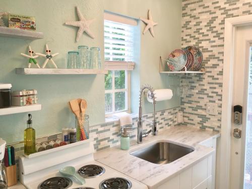 a kitchen with a sink and a counter top at Coastal Studio Escape! in Naples