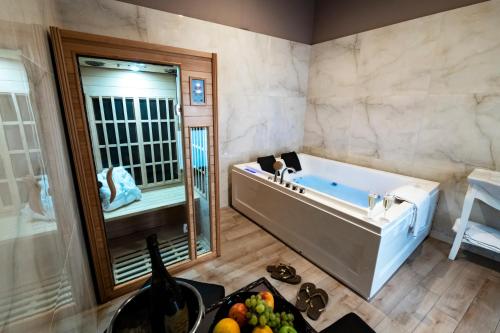 a bathroom with a tub and a sink and a mirror at Villa Elisio Hotel & Spa in Naples