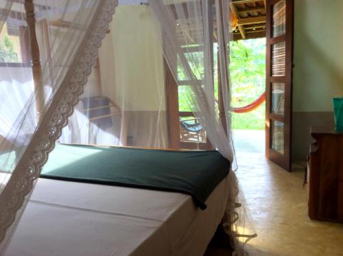 a bed with a canopy in a room at Natural Mystic Sanctuary in Deniyaya