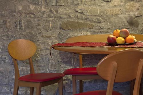 a table with two chairs and a bowl of fruit on it at Mulino Baiar in Stregna