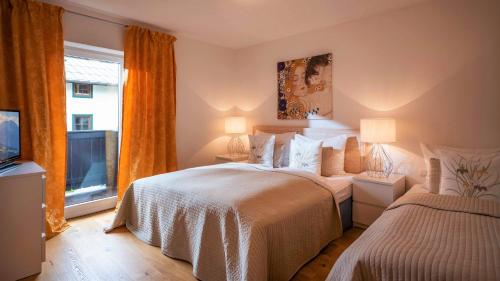 a bedroom with two beds and a window at Chalet Schott in Kirchberg in Tirol