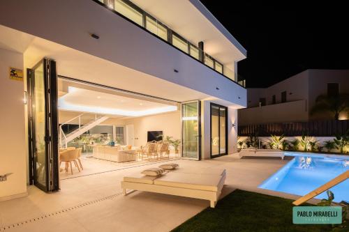 a house with a swimming pool and a patio at Villa The Palms in Meloneras