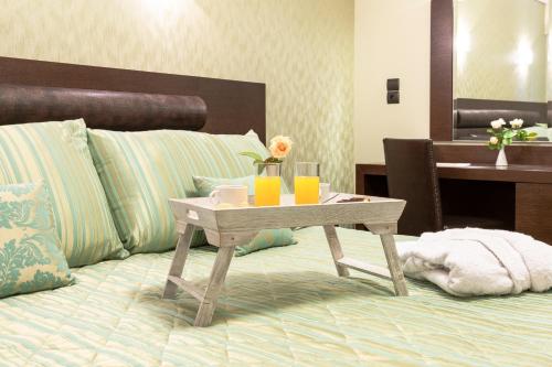 a table on a bed with a tray on it at Thermios Apollon in Thermo