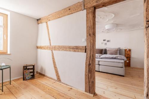 a room with a bed and wooden beams at maindrei - schlafen am fluss in Margetshöchheim