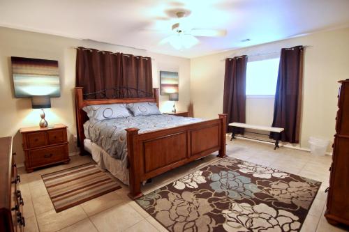 a bedroom with a bed with a wooden bed frame at The Guadalupe Escape in New Braunfels