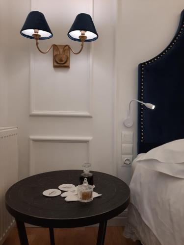 a black table in a bedroom with a bed and two lamps at Esperia Boutique Hotel in Agrinion