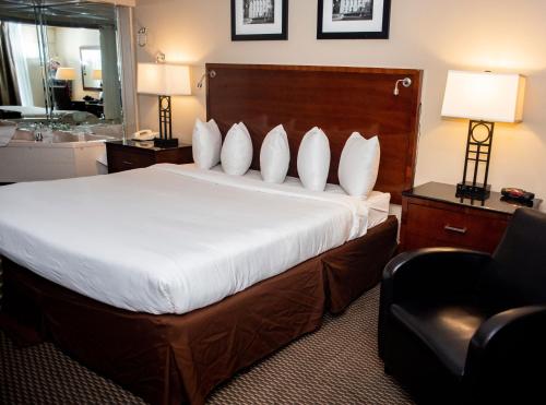 a hotel room with a bed and a bathroom at Altoona Grand Hotel in Altoona