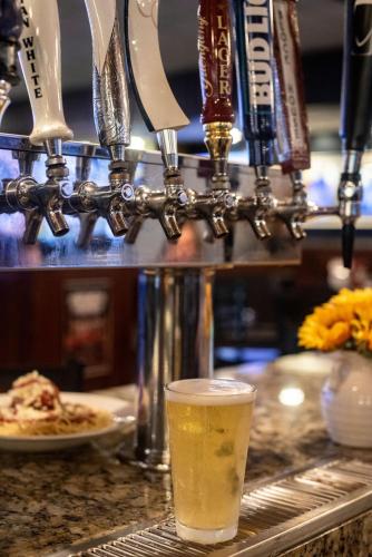 a glass of beer sitting on top of a counter at Altoona Grand Hotel in Altoona
