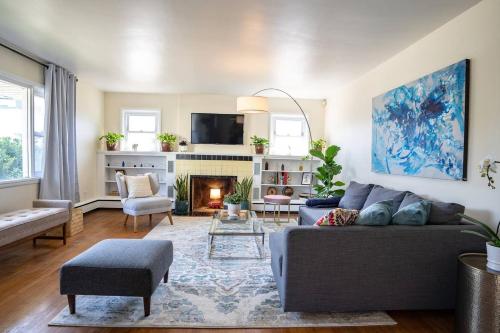 a living room with a couch and a fireplace at Fabulous Mid Century 4BR 3Bath House in Atlantic City