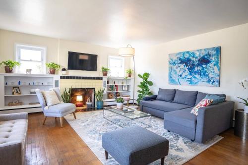 a living room with a blue couch and a fireplace at Fabulous Mid Century 4BR 3Bath House in Atlantic City