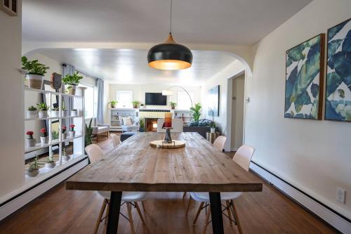 a living room with a wooden table and chairs at Fabulous Mid Century 4BR 3Bath House in Atlantic City