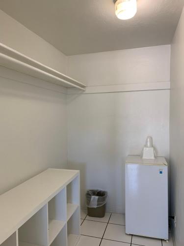 a white room with a counter and a refrigerator at International Inn on the Bay in Miami Beach