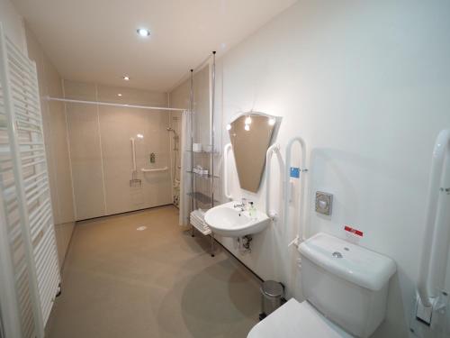 a bathroom with a toilet and a sink and a shower at Park Hotel in Thurso