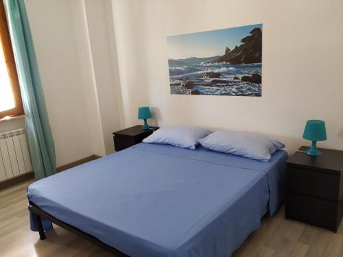 um quarto com uma cama e um quadro na parede em Bell'appartamento em Portoferraio